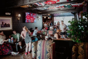 Image shows interior of bar showing a Kansas City Chiefs football game