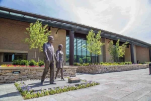 Image of building with bronze sculpture of two people walking