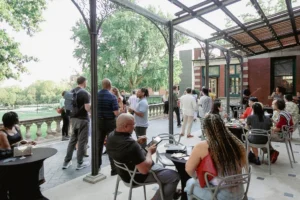Image shows group of people gathered outside on a patio.