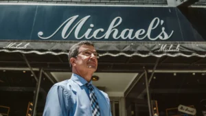Image shows a man standing in front of Michael's in Kansas City.